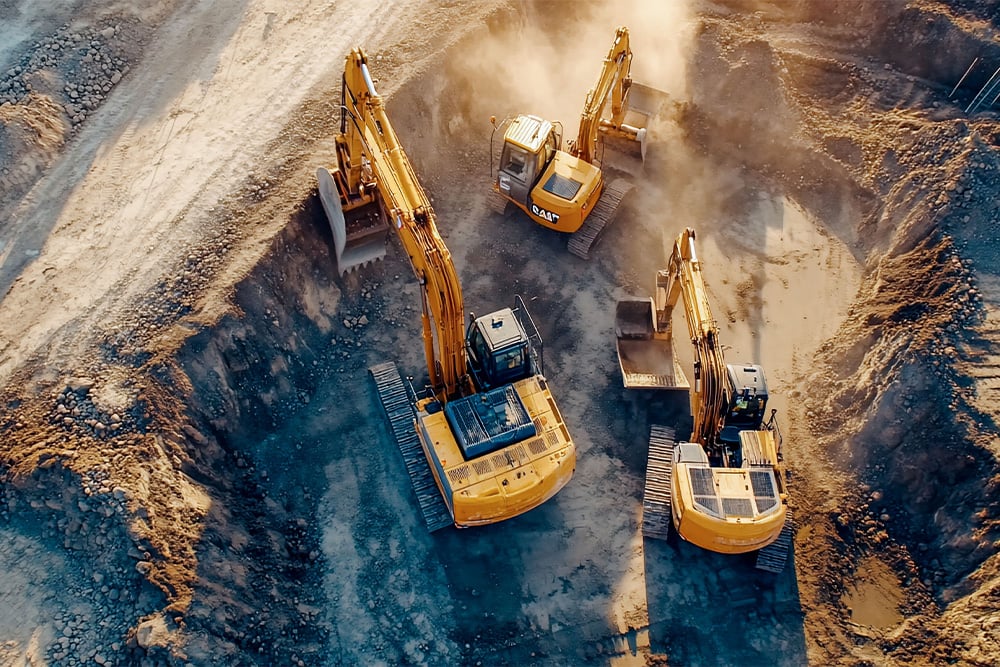 Three excavators in the pit