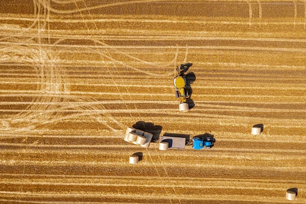 Aerial view of agricultural harvesting machinery in field