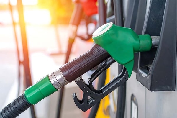 Green fuel nozzle at petrol station dispenser