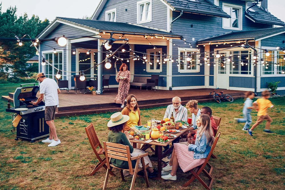 Family gathering in the garden of a detached house with focus on comfortable residential energy supply 