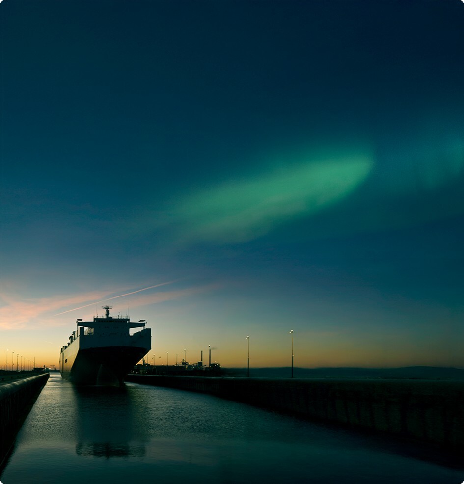 A container ship under the Northern Lights as a symbol of alternative marine fuels and sustainable fleet planning 