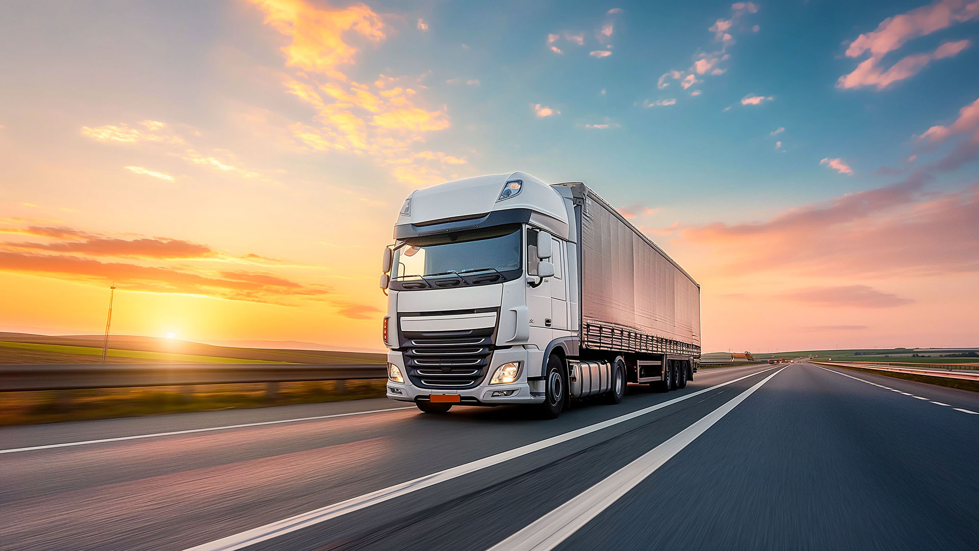Truck on highway at sunset